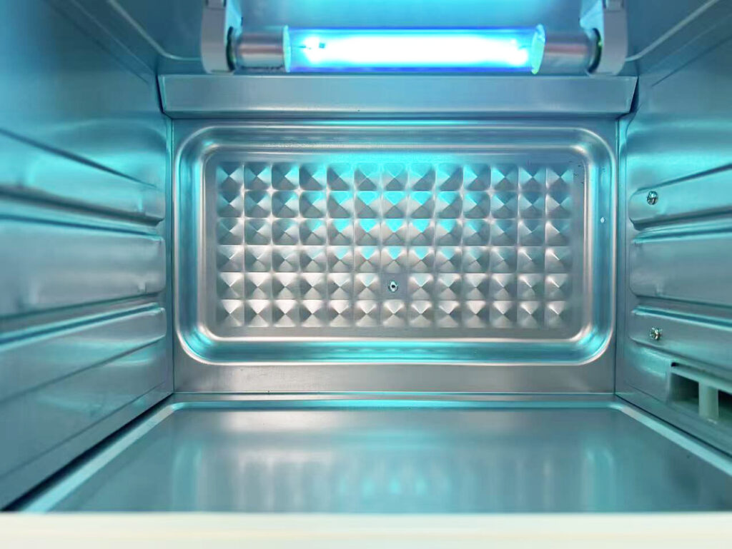 Photo of the UV lamp inside the disinfection cabinet lighting up